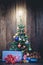 Christmas tree with colorful ornaments a wood background