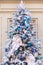 Christmas tree decorated with artificial snow, blue balls and figurines