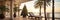 A Christmas tree is decorated on the balcony of a hotel with sun beds by the sea on vacation in a tropical country with palm trees