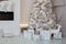 Christmas tree decorated with toys, balls and lights glowing garlands in living room. Christmas decorations concept. Cozy xmas. Be