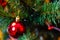 Christmas tree decoration. Balls, stars garland on a tree. Red bows on a New Year tree. The festive tree is decorated with bright