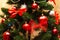 Christmas tree decoration. Balls, stars garland on a tree. Red bows on a New Year tree. The festive tree is decorated with bright