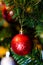 Christmas tree decoration. Balls, stars garland on a tree. Red bows on a New Year tree. The festive tree is decorated with bright