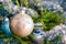 Christmas-tree decoration bauble on decorated Christmas tree bac