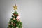 Christmas tree with decoration, grey background