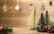 Christmas tree decoration on wood table with copy space.pine cone,mistletoe and bell ball hanging with blur wood wall background.