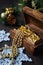 Christmas-tree decorations and goldish garland in carved wooden