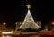 Christmas tree and decorations near the Ria de Aveiro with Moliceiro boats at night