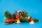 Christmas tree decorations. , pinecones , pine branches and small gold bells on a blue background. Holiday concept.