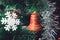 Christmas Tree Decorations: Red Orange Bell, White Snowflake, Shining Silver Tinsel on Green Needles with White Tips. Happy New