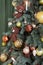 Christmas tree decorations. Toy knitted bear, garland lights and vintage balls on spruce. Close up shot