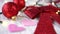 Christmas-tree decorations on a white wooden table. red bow and ball, pink hearts