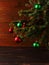 Christmas tree, dressed up balls, stands on a wooden table. Copy space