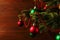 Christmas tree, dressed up balls, stands on a wooden table. Copy space