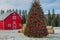 A Christmas tree farm with a red barn and hay bales in the background, Generated AI