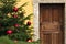 Christmas tree festive decorated outdoor exterior facade entrance part of house with wooden door wall