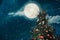 Christmas tree with full moon background in winter.