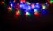 Christmas tree garland laid out on a wooden table