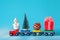 Christmas tree and gift box, ball and snowman on toy train on blue background. Gifts and congratulations concept