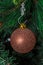Christmas tree hanging ornament, bronze globe, close up