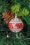 Christmas tree hanging ornament, red globe with reindeer, close