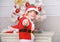 Christmas tree ideas for kids. Boy kid dressed as cute elf magical creature white artificial ears and red hat near