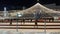 Christmas tree with lights on Ice Rink. People skating on an open air ice skating rink. Winter outdoor activities.