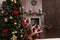 Christmas tree in the living room with decorated fireplace