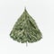 Christmas tree made with cedar branches on white desk background, top view. Layout of holiday greeting card for festive decorating