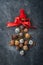 Christmas tree made of chocolate truffles, hazelnuts, anise stars, decorations, spoons and powdered sugar snow on dark background.