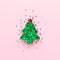 Christmas tree made of cookie form and green confetti at pastel pink background. Creative festive decoration concept