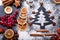 Christmas tree made from flour on a dark table, frozen cranberry