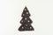 Christmas tree made from freshly roasted coffee beans with candies sweetmeats on white table. Winter concept. Creative.