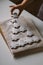 Christmas tree made of gingerbread cookies sprinkled with powdered sugar on wooden board