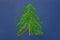 Christmas tree made from green fern twigs branches wood knot on dark blue background. New Year greeting card