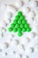 Christmas tree made of green pills and tablet on white background. new year`s card concept for medical field. mockup