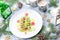 Christmas tree made of kiwi and fruit jelly on a plate with fir branches and decorations. Top view, copy space