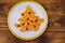 Christmas tree made of mandarin lobules and pomegranate on wooden table. Top view