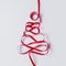 Christmas tree made of red ribbon. Minimal Christmas concept