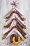 Christmas tree made of sausage on a background of a wooden wall