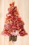 Christmas tree made of sausage on a background of a wooden wall