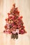 Christmas tree made of sausage on a background of a wooden wall