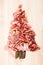 Christmas tree made of sausage on a background of a wooden wall