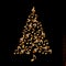 Christmas tree made of shiny golden musical notes on black