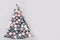 Christmas tree made of stars, confetti, silver pastel balls on grey background. Xmas composition. Flat lay, top view, copy space.