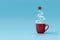 Christmas tree made of steaming coffee with red star. Morning drink. Christmas or New Year celebration concept. Copy space