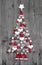 Christmas tree made up of decoration on grey wooden background