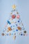 Christmas tree made of various decorative ocean items: seashells, starfish, vessels, lighthouses, lifebuoys, steering wheels,