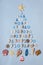 Christmas tree made of various seashells, sea stars, decorative items and miniature toys: lighthouses, life buoys, steering wheels