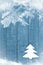 Christmas tree made from white felt on wooden, blue background. Snow flaks image. Christmas tree ornament, craft